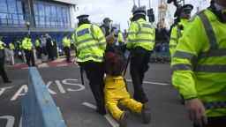 LONDON, ENGLAND - OCTOBER 10: A protesters is removed by police as climate change action group Extinction Rebellion stage a protest at London City Airport during the fourth day of demonstrations on October 10, 2019 in London, England. Climate change activists have gathered to block access to various government departments as they launch a two week protest in central London.  (Photo by Peter Summers/Getty Images)
