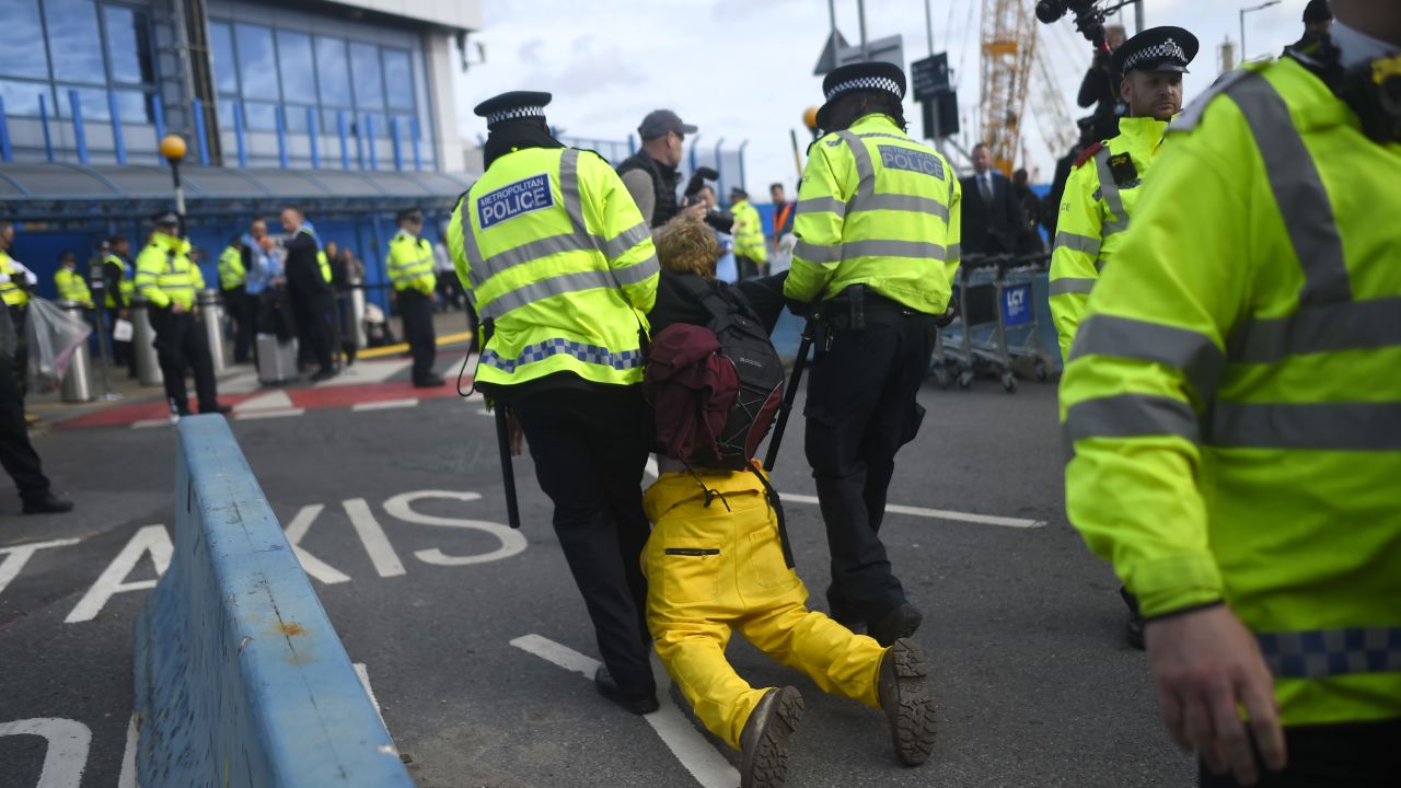 A protester is removed by police as Extinction Rebellion stage a protest at London City Airport on October 10. 