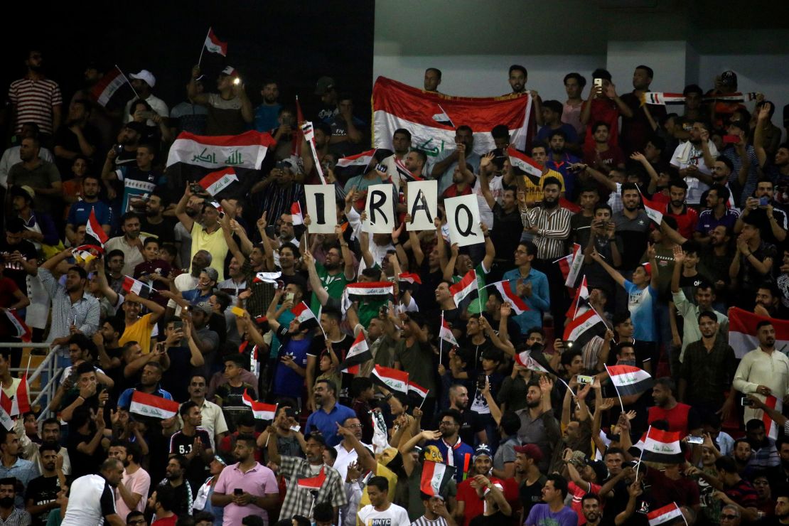 Iraq supporters cheer during the the 2019 WAFF Championship football match between Syria and Iraq in Karbala on August 8, 2019.