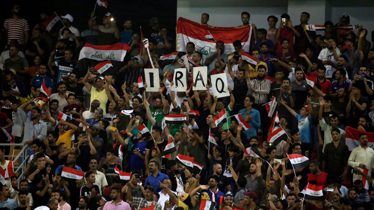 Iraq supporters cheer during the the 2019 WAFF Championship football match between Syria and Iraq in Karbala on August 8, 2019.
