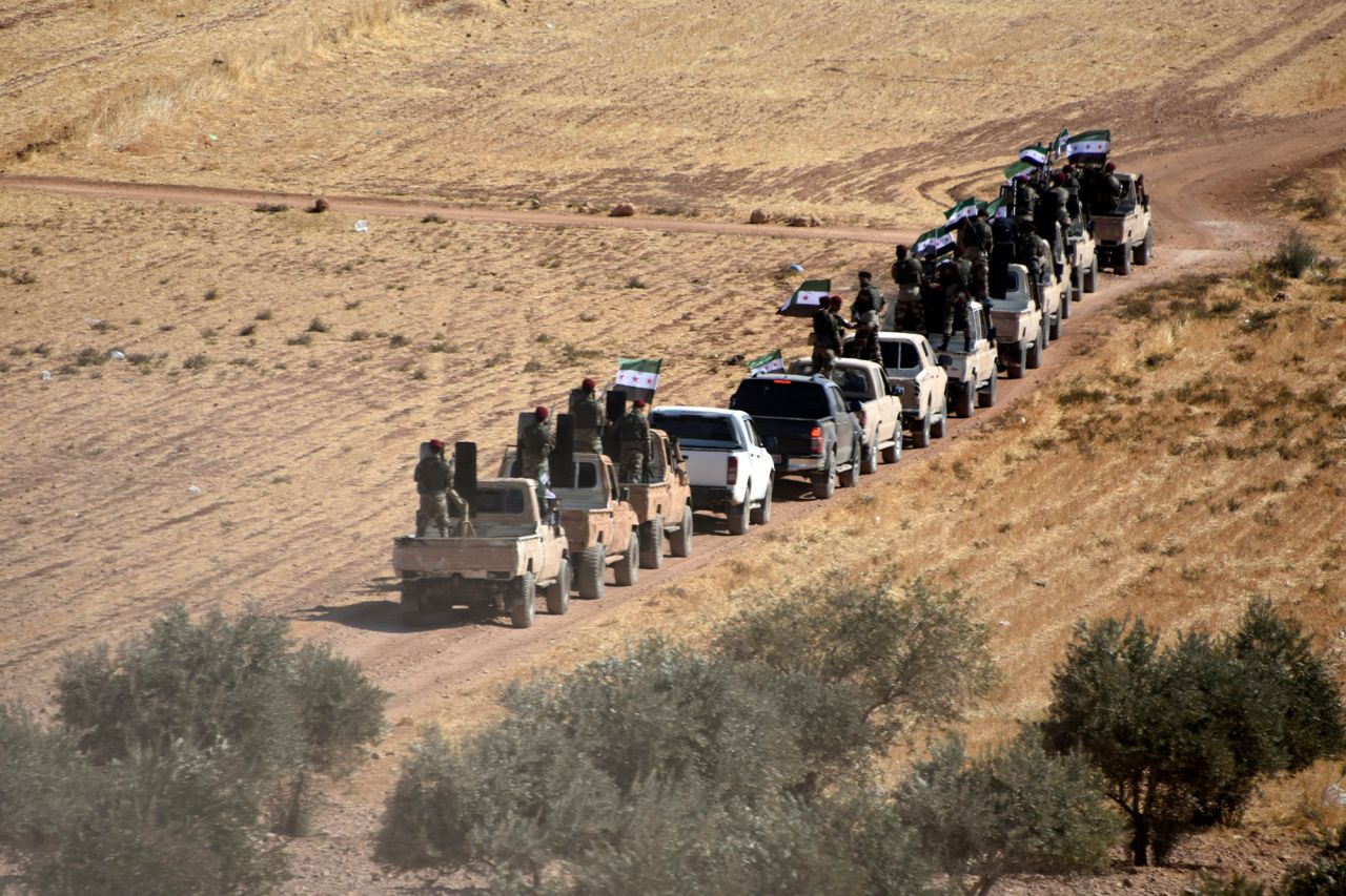 Turkish-backed fighters of the Free Syrian Army head toward Tal Abyad, Syria, on Thursday, October 10.