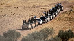 Turkey-backed FSA fighters are heading toward Syrian town of Tal Abyad from Turkish border town of Akcakale, Turkey, Thursday, Oct. 10, 2019. Turkish President Recep Tayyip Erdogan says that there have been 109 "terrorists killed" — a reference to Syrian Kurdish fighters — since Ankara launched an offensive into Syria the previous day.  (DHA via AP)