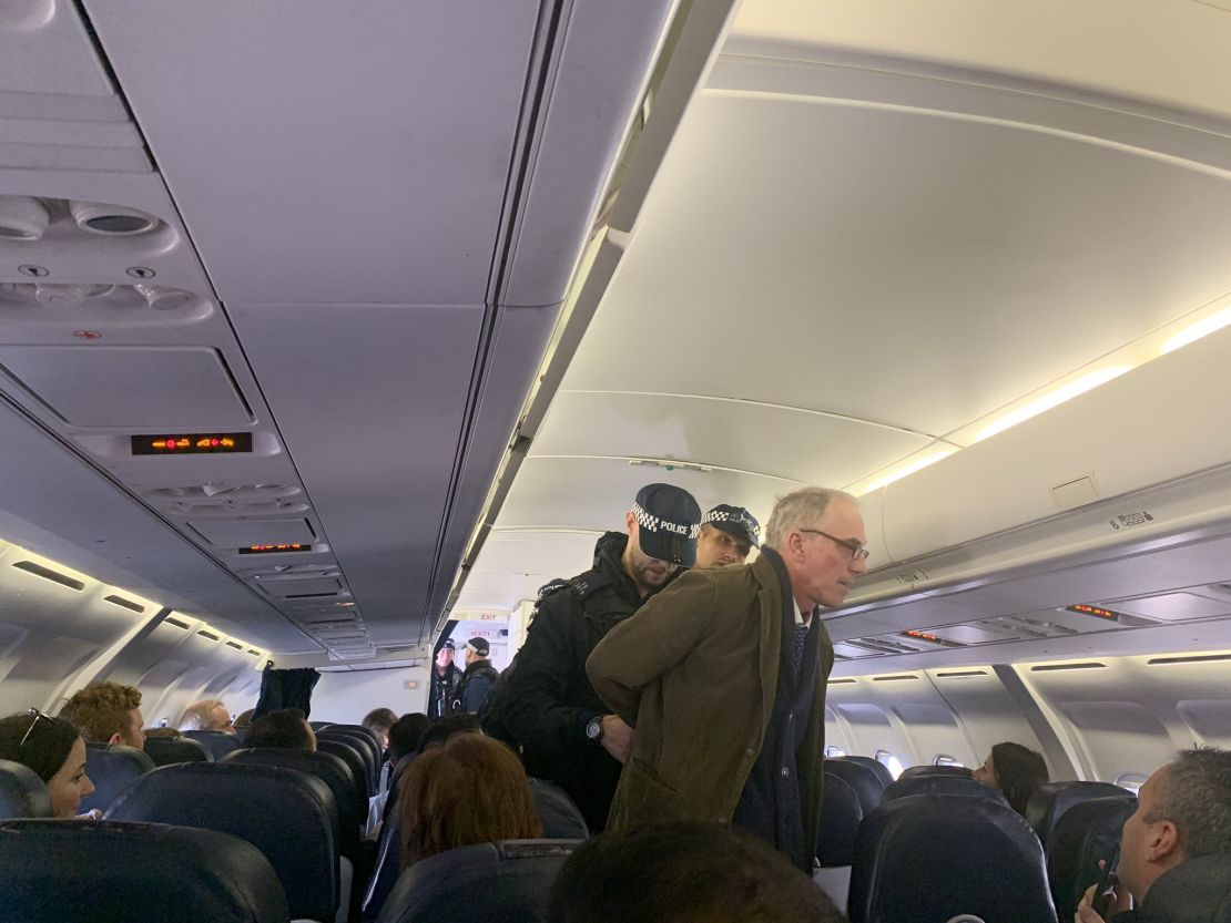 A protester is arrested after refusing to sit down on a flight to Dublin.