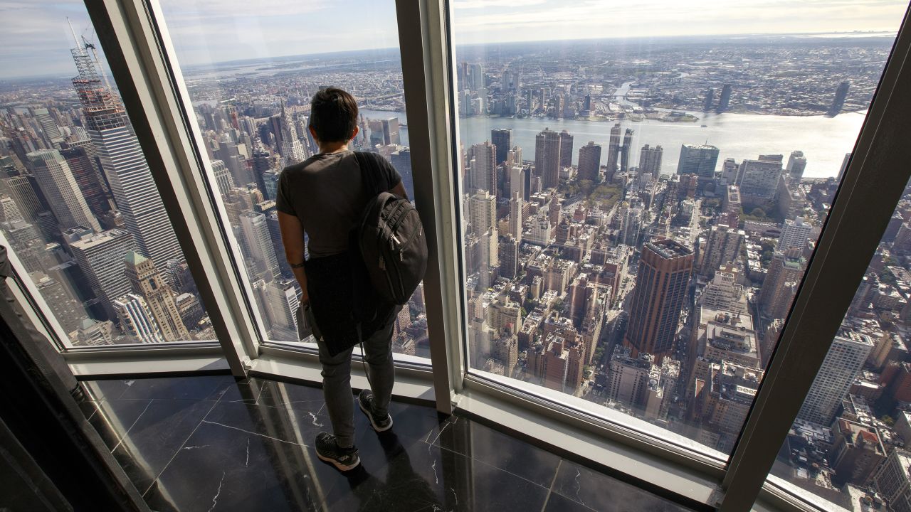 Visitors take in views of Manhattan from the newly renovated 102nd floor observatory of the Empire State Building.