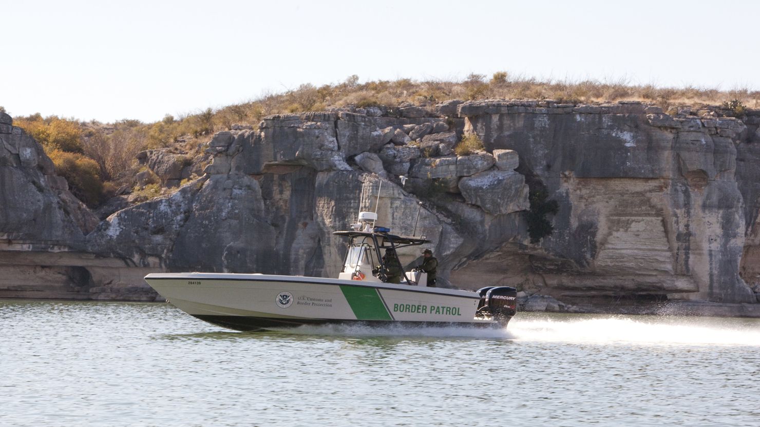 A dual-engine Border Patrol boat surveys the Rio Grande west of Del Rio, Texas. 
