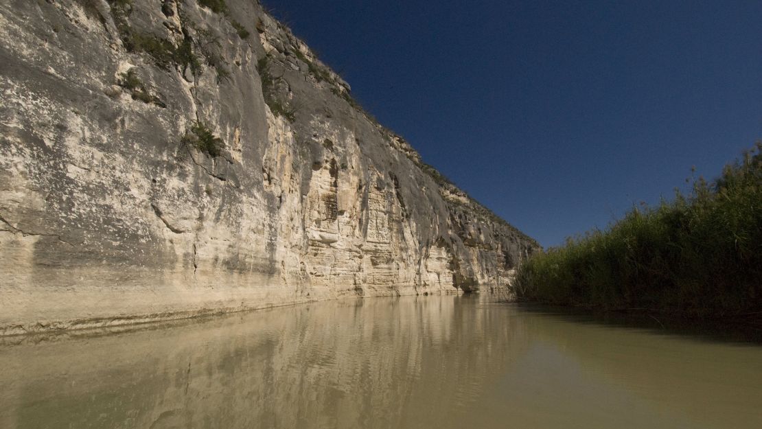 Rugged cliffs along the Rio Grande in Val Verde County, Texas, form a natural barrier between Mexico (right) and the US. 