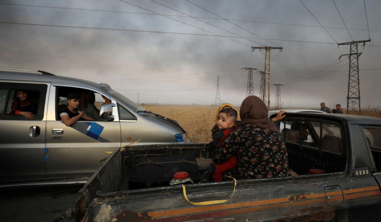 People flee the Syrian city of Ras al-Ayn after Turkey <a href="http://www.cnn.com/2019/10/09/middleeast/gallery/turkey-syria-conflict/index.html" target="_blank">launched a military offensive</a> in northeastern Syria on Wednesday, October 9. The offensive is aimed at pushing Kurdish forces away from Turkey's border with Syria.