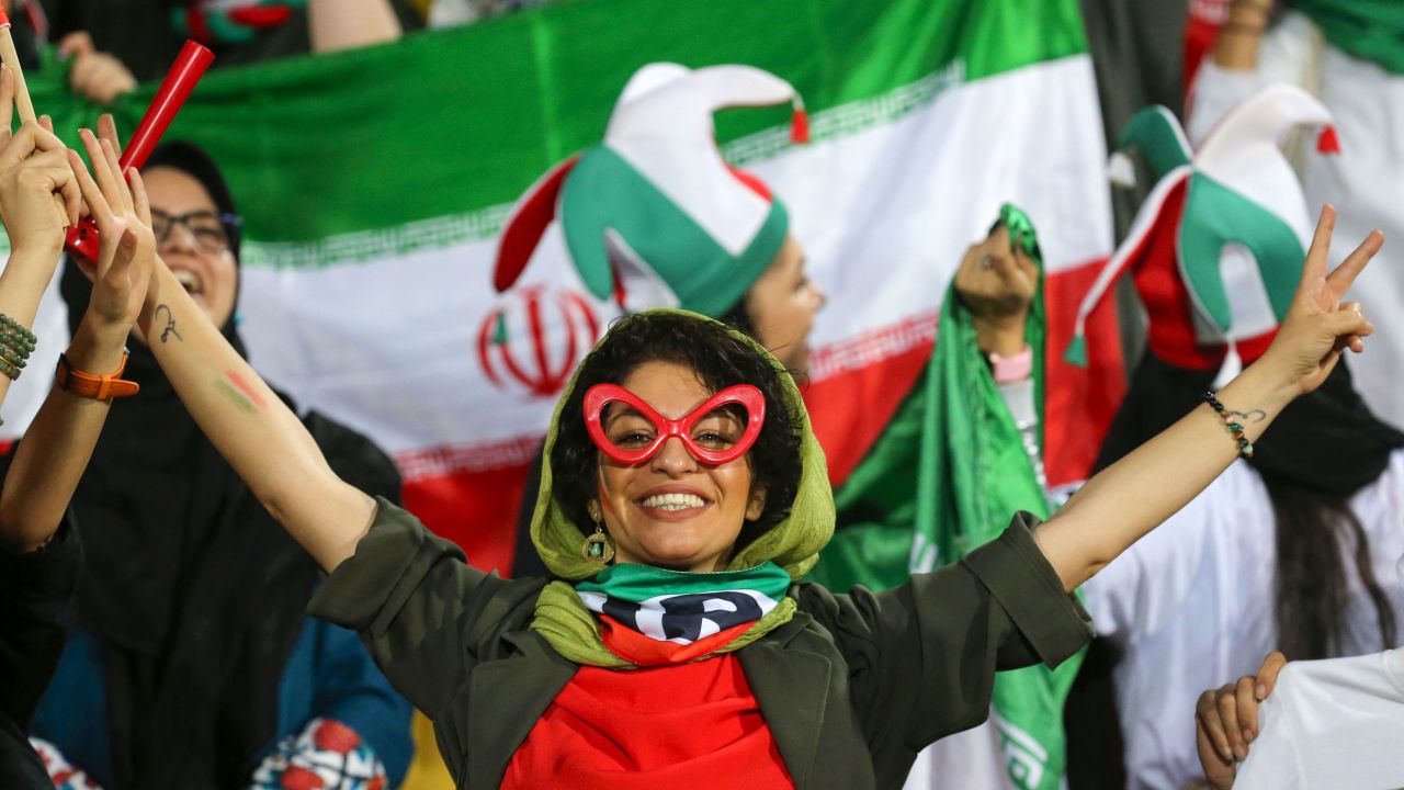 An Iranian woman cheers during the World Cup qualification match between Iran and Cambodia at the Azadi stadium in the capital Tehran on October 10, 2019.