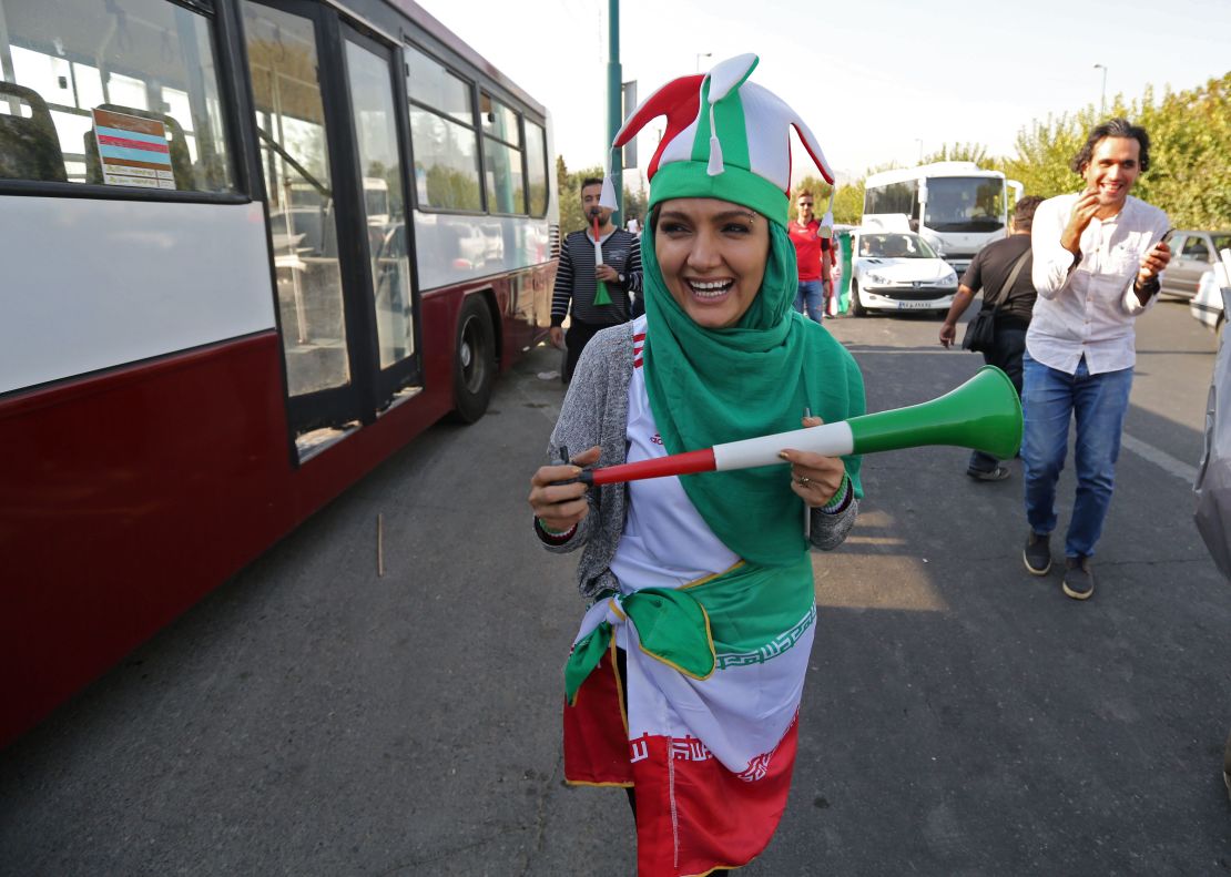 An Iranian woman wearing her country's national colours arrives at the Azadi stadium.