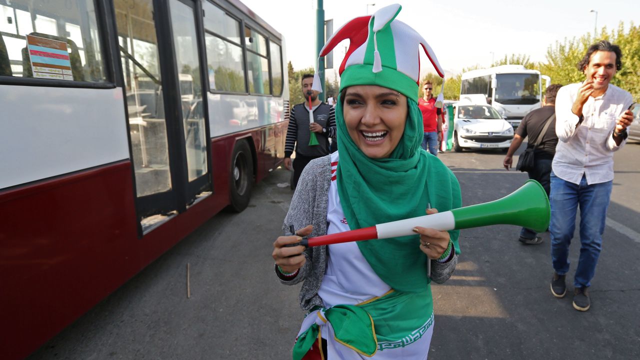 An Iranian woman wearing her country's national colours arrives at the Azadi stadium.