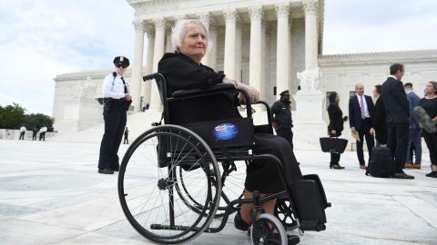 Aimee Stephens sits in her wheelchair outside the US Supreme Court in October 2019 as the court hears oral arguments in cases dealing with workplace discrimination based on sexual orientation. 