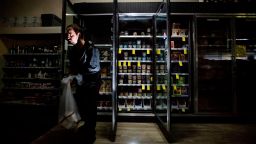CVS Pharmacy shift supervisor James Quinn throws out ice cream from darkened freezers as downtown Sonoma, Calif., remains without power on Wednesday, Oct. 9, 2019. Pacific Gas and Electric has cut power to more than half a million customers in Northern California hoping to prevent wildfires during dry, windy weather throughout the region. (AP Photo/Noah Berger)