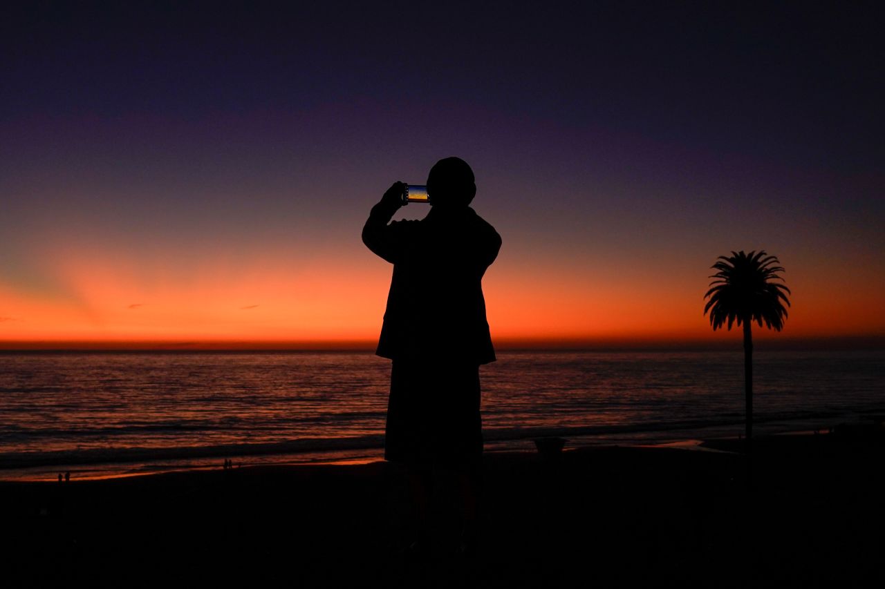 A man uses his phone to take a picture after the sun set in Encinitas, California, on Monday, October 7. <a href="http://www.cnn.com/2019/10/03/world/gallery/week-in-photos-1003/index.html" target="_blank">See last week in 29 photos</a>