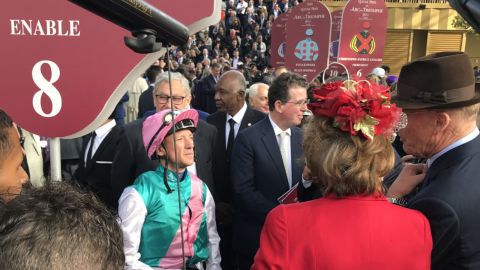 The ring was packed for Sunday's big race. All eyes were on veteran Italian jockey Dettori. Enable's trainer John Gosden (right) offered last-minute words.