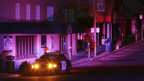 Police officers patrol a street during a power outage in Oakland, California.