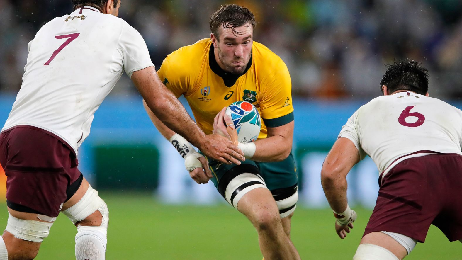 Australia's Izack Rodda runs at Georgia's Mamuka Gorgodze, left, and Beka Saginadze during the Rugby World Cup Pool D game at Shizuoka Stadium Ecopa between Australia and Georgia in Shizuoka, Japan on Friday. 