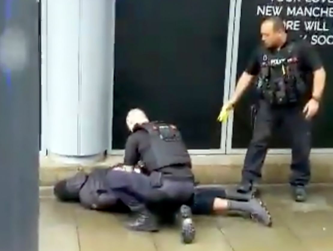 In this image taken from mobile phone footage, police arrest a man outside the Arndale Center.