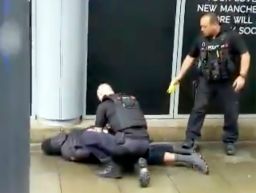 In this image taken from mobile phone footage, police arrest a man outside the Arndale Center.