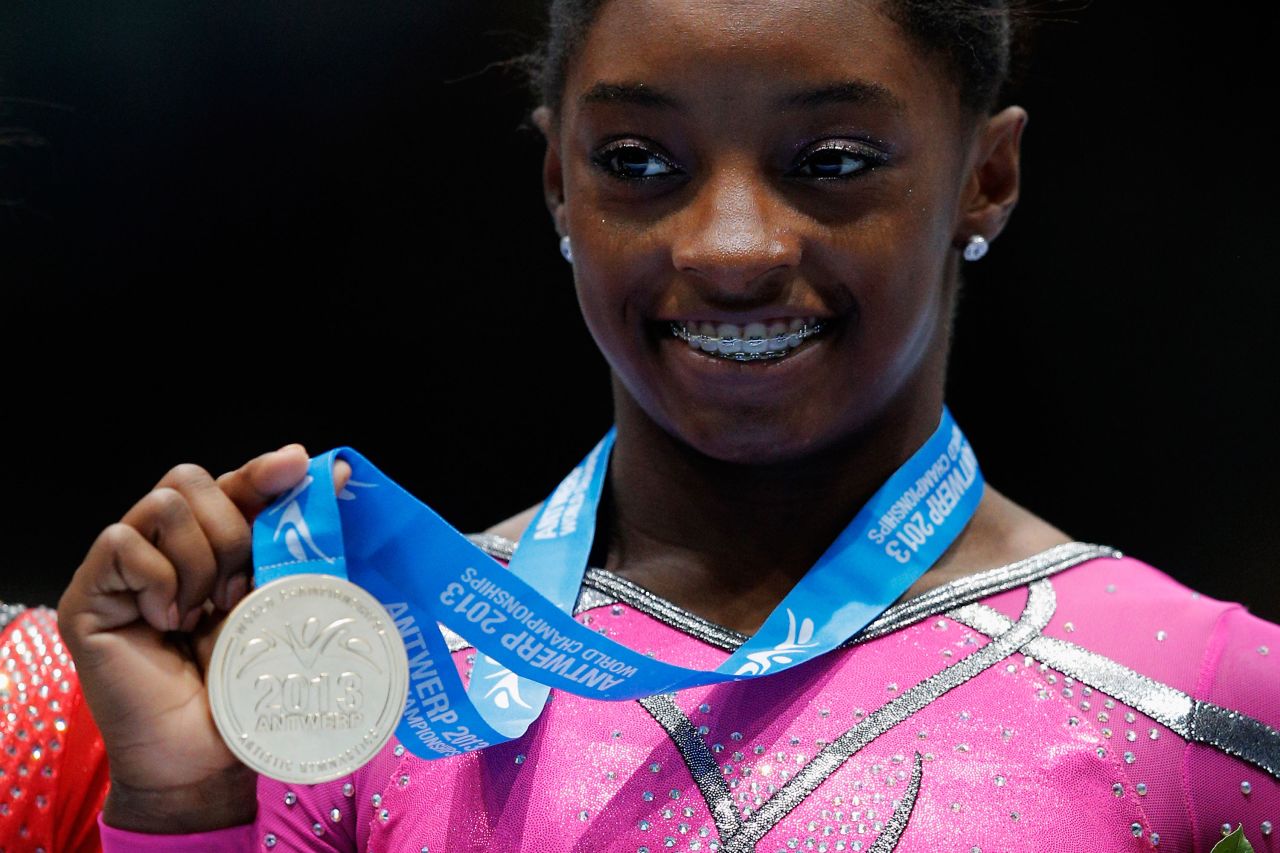 Biles poses after winning the gold medal in the floor exercise at the 2013 World Championships.