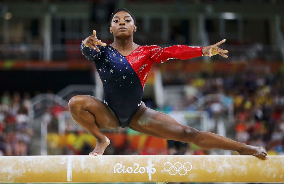 Biles competes on the balance beam at the 2016 Olympics in Rio de Janeiro. She won gold in the individual all-around and the team all-around. She also added two more golds and a bronze.