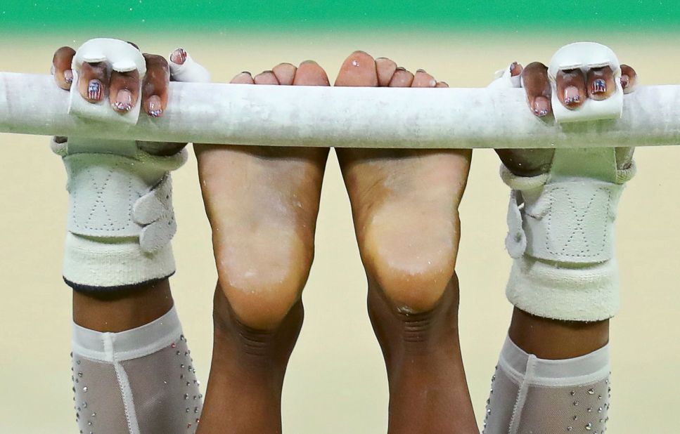 Biles competes on the uneven bars at the 2016 Olympics.