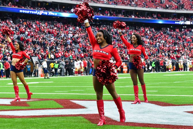 Biles performs with the Houston Texans cheerleaders in December 2017.