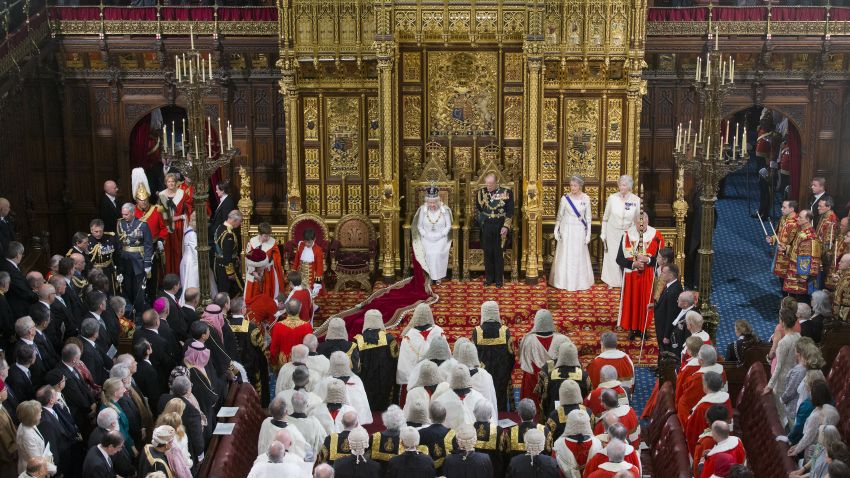 LONDON, ENGLAND - MAY 18:  Queen Elizabeth II prepares to deliver the Queen's Speech from the throne as Prince Philip, Duke of Edinburgh looks on (R) and Prince Charles, Prince of Wales (L) and Camilla, Duchess of Cornwall arrive during State Opening of Parliament in the House of Lords at the Palace of Westminster on May 18, 2016 in London, England. The State Opening of Parliament is the formal start of the parliamentary year. This year's Queen's Speech, setting out the government's agenda for the coming session, is expected to outline policy on prison reform, tuition fee rises and reveal the potential site of a UK spaceport. (Photo by Justin Tallis - WPA Pool/Getty Images)