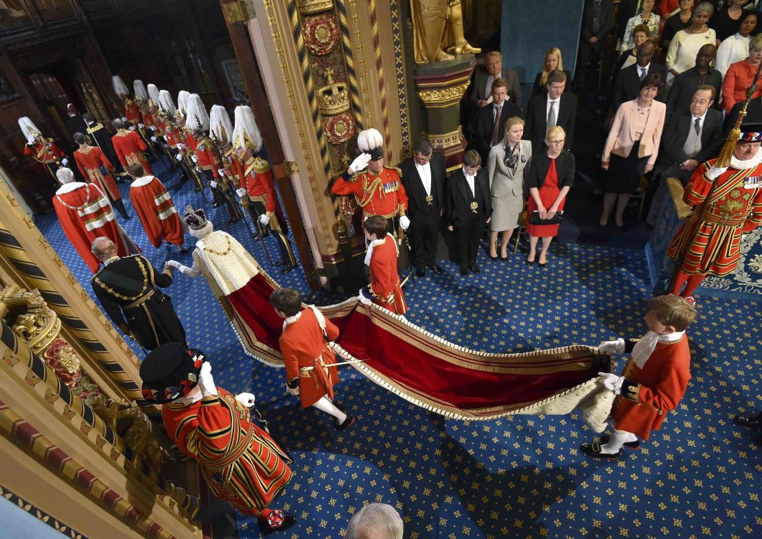 Queen Elizabeth II proceeds through the Royal Gallery before the State Opening of Parliament in 2016.