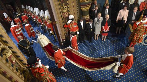 Queen Elizabeth II proceeds through the Royal Gallery before the State Opening of Parliament in 2016.