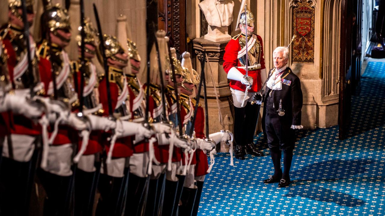 Black Rod waits at the bottom of the stairs before the arrival of Queen Elizabeth II.