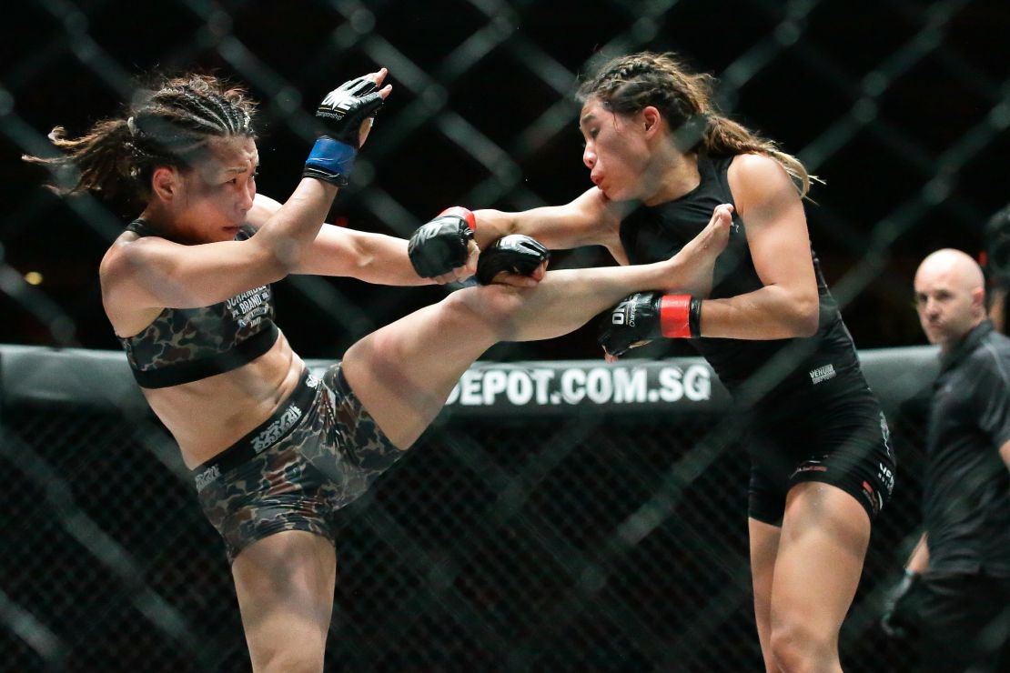 Mei Yamaguchi (L) fights Angela Lee of Singapore during One Championship: Ascent to Power at Singapore Indoor Stadium in 2016.