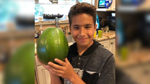  Lo'ihi Pokini holds his family's 5.6 pound avocado, which was just certified as the world's heaviest.