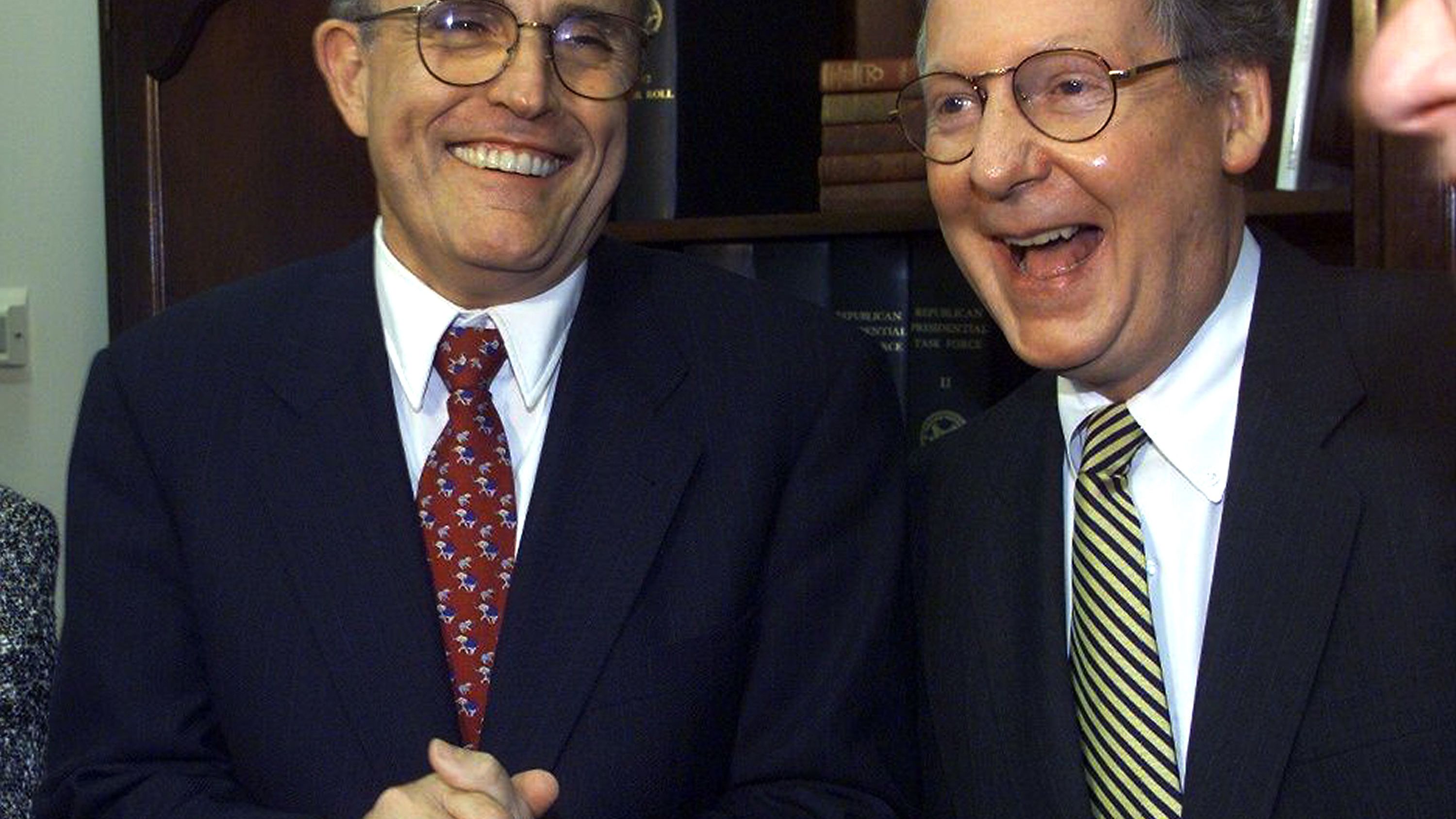 Giuliani shares a laugh with US Sen. Mitch McConnell at a Republican fundraiser in Washington in April 1999.