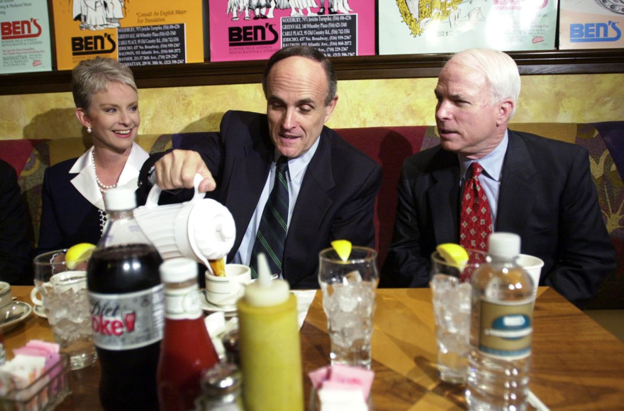 Giuliani pours coffee as he has breakfast with US Sen. John McCain and McCain's wife, Cindy, in April 2000. McCain came to New York to campaign for Giuliani, who was running for a US Senate seat. Giuliani dropped out of the race after announcing that he had prostate cancer and wanted to focus on treatment.