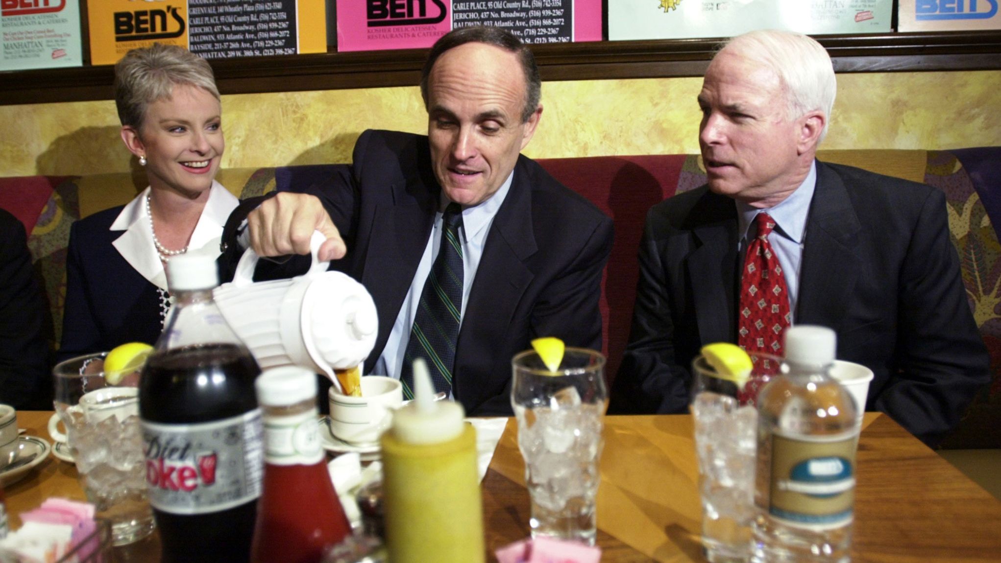 Giuliani pours coffee as he has breakfast with US Sen. John McCain and McCain's wife, Cindy, in April 2000. McCain came to New York to campaign for Giuliani, who was running for a US Senate seat. Giuliani dropped out of the race after announcing that he had prostate cancer and wanted to focus on treatment.