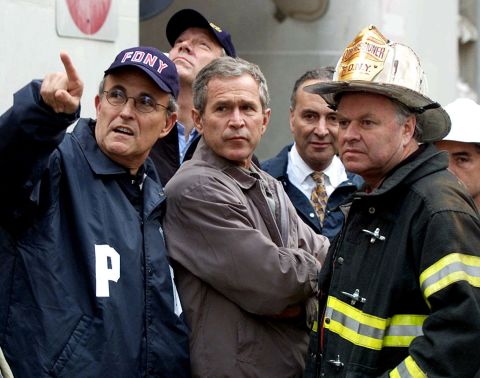 Giuliani, left, accompanies US President George W. Bush and other officials during a tour of the fallen World Trade Center in September 2001.