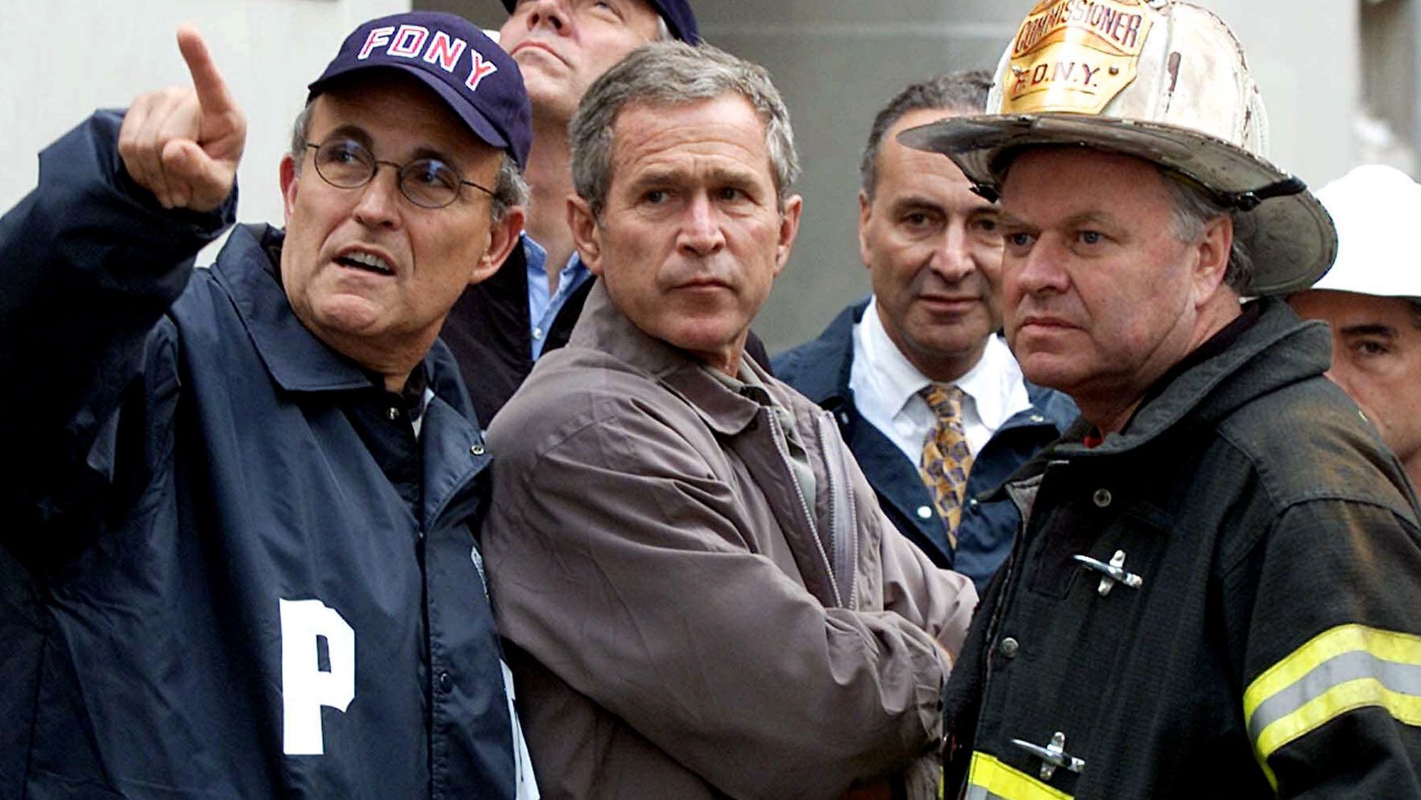 Giuliani, left, accompanies US President George W. Bush and other officials during a tour of the fallen World Trade Center in September 2001.