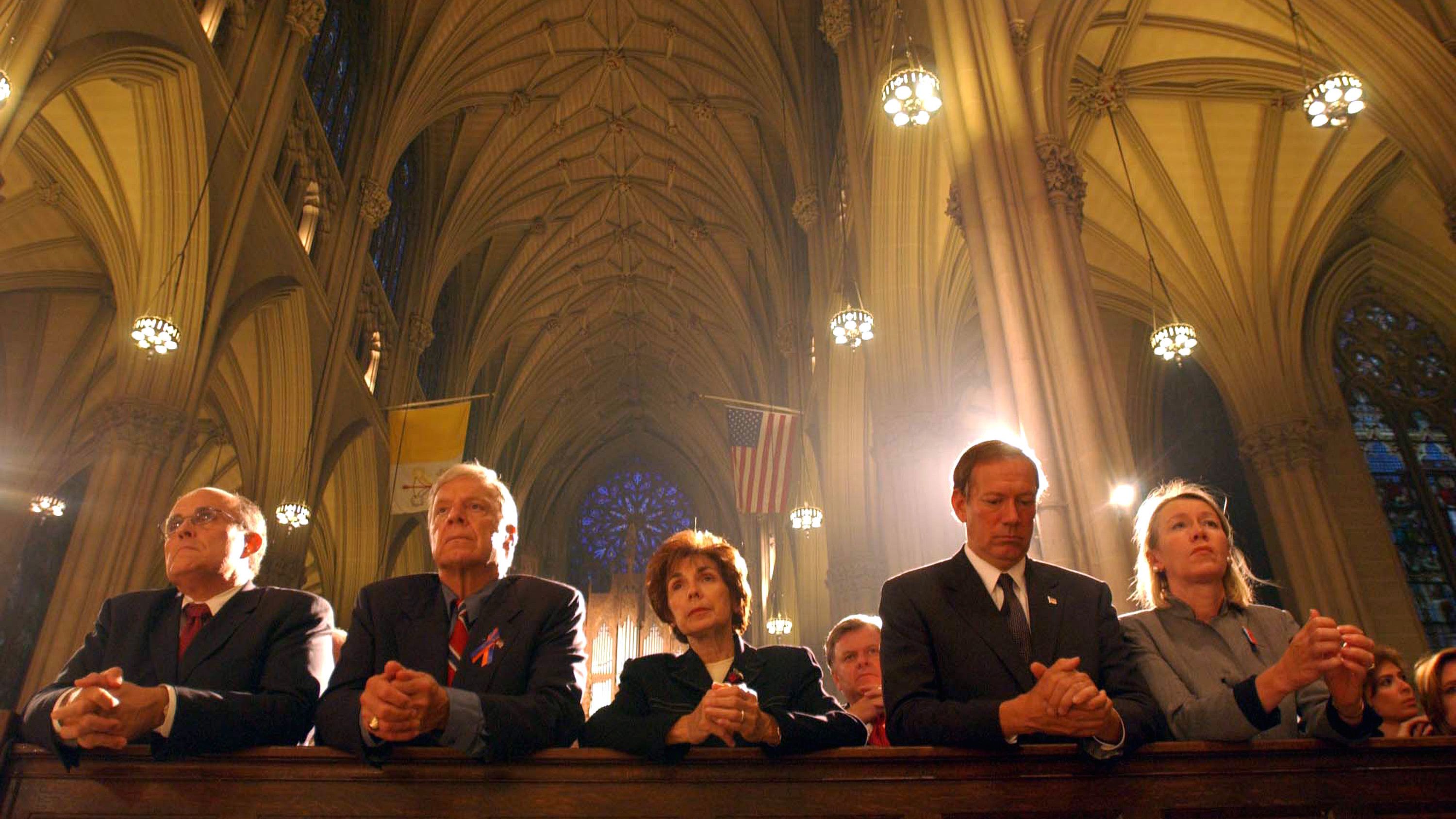 Giuliani, left, prays at St. Patrick's Cathedral a few days after the September 11 attacks. At right is New York Gov. George Pataki and his wife, Libby.