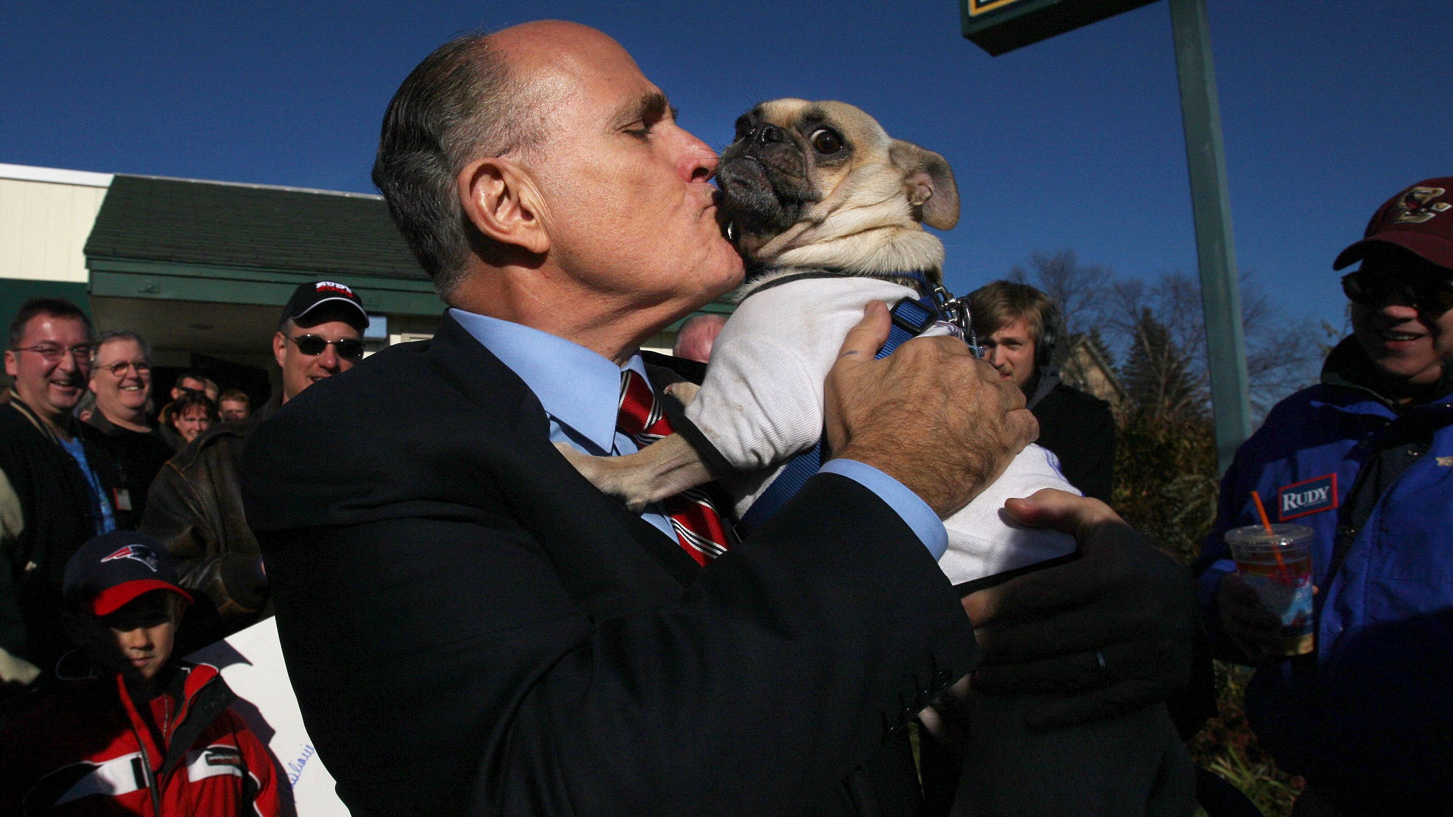 Giuliani kisses Thompson the pug while campaigning in New Hampshire in November 2007. The dog was wearing a shirt that said, "Anybody but Hillary for president."