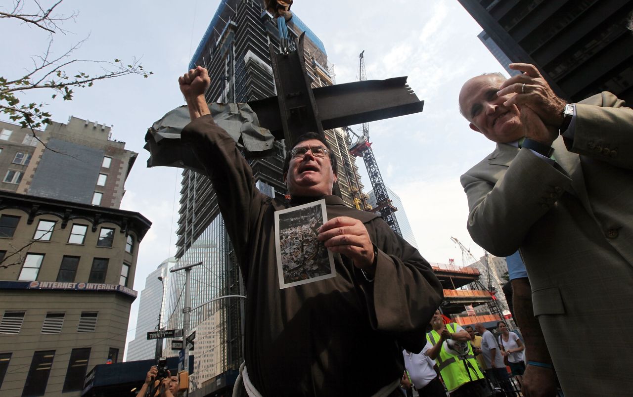 Giuliani joins the Rev. Brian Jordan during a blessing of the World Trade Center cross in July 2011. The cross, which was discovered in the World Trade Center rubble, was being moved into its permanent home at the 9/11 Memorial Museum.