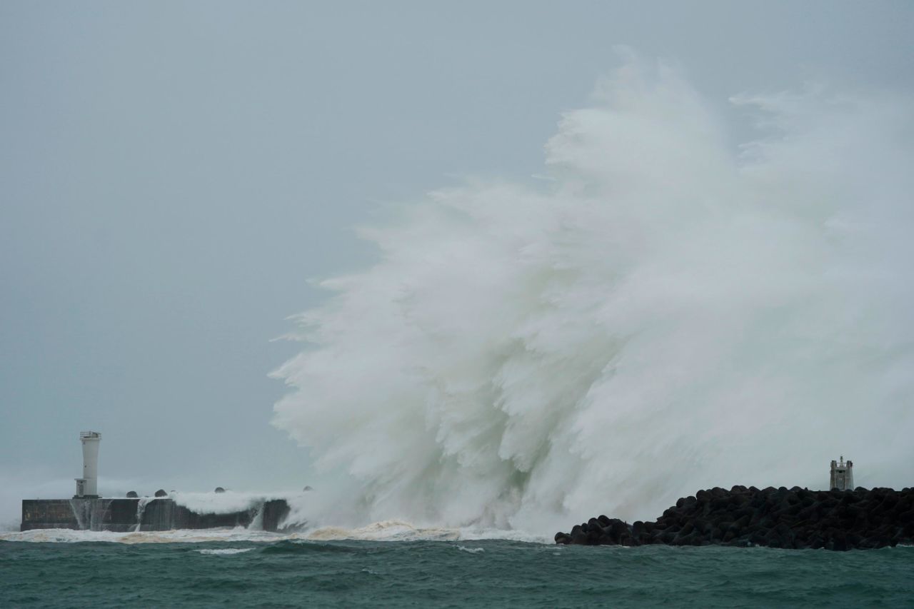 Surging waves hit against the breakwater in Kiho, Japan, on October 12.
