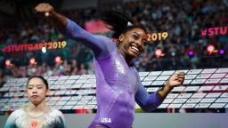 USA's Simone Biles (R) celebrates after winning the beam apparatus final as second placed China's Liu Tingting looks on at the FIG Artistic Gymnastics World Championships at the Hanns-Martin-Schleyer-Halle in Stuttgart, southern Germany, on October 13, 2019.