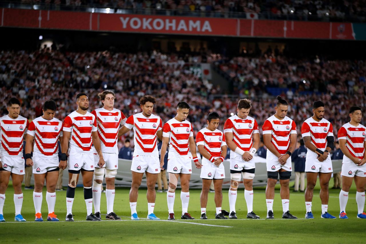 Japan's players line up for a minute of silence for the victims of Typhoon Hagibis prior to their match against Scotland. At least 15 people were killed and 140 are missing after Japan's worst storm in decades.