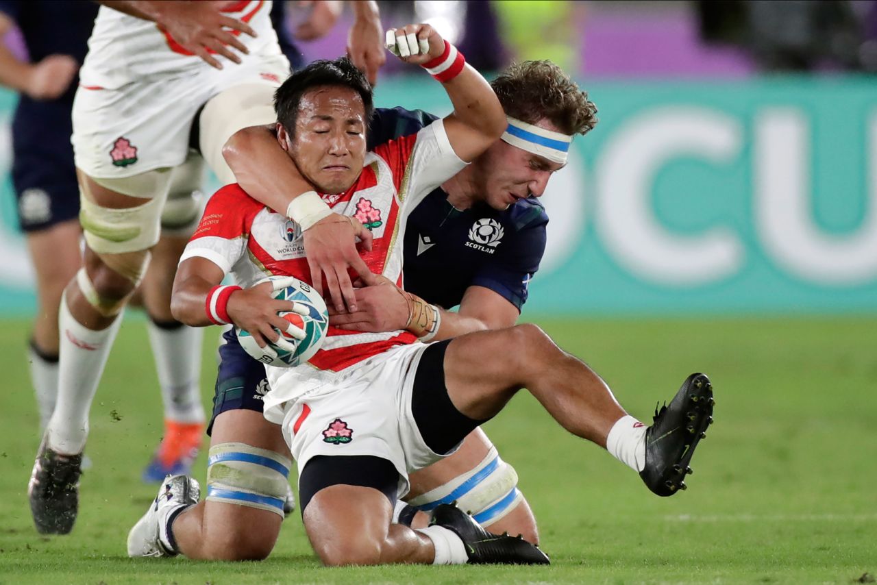 Japan's Yutaka Nagare grabs the ball against Scotland's Jamie Ritchie.