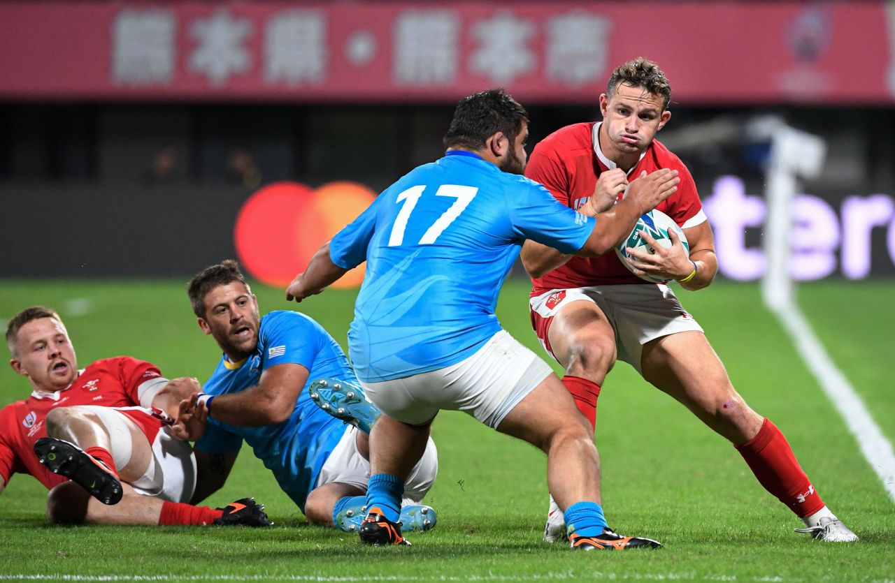 Wales winger Hallam Amos runs with the ball as Uruguay's prop Juan Echeverria goes to tackle.