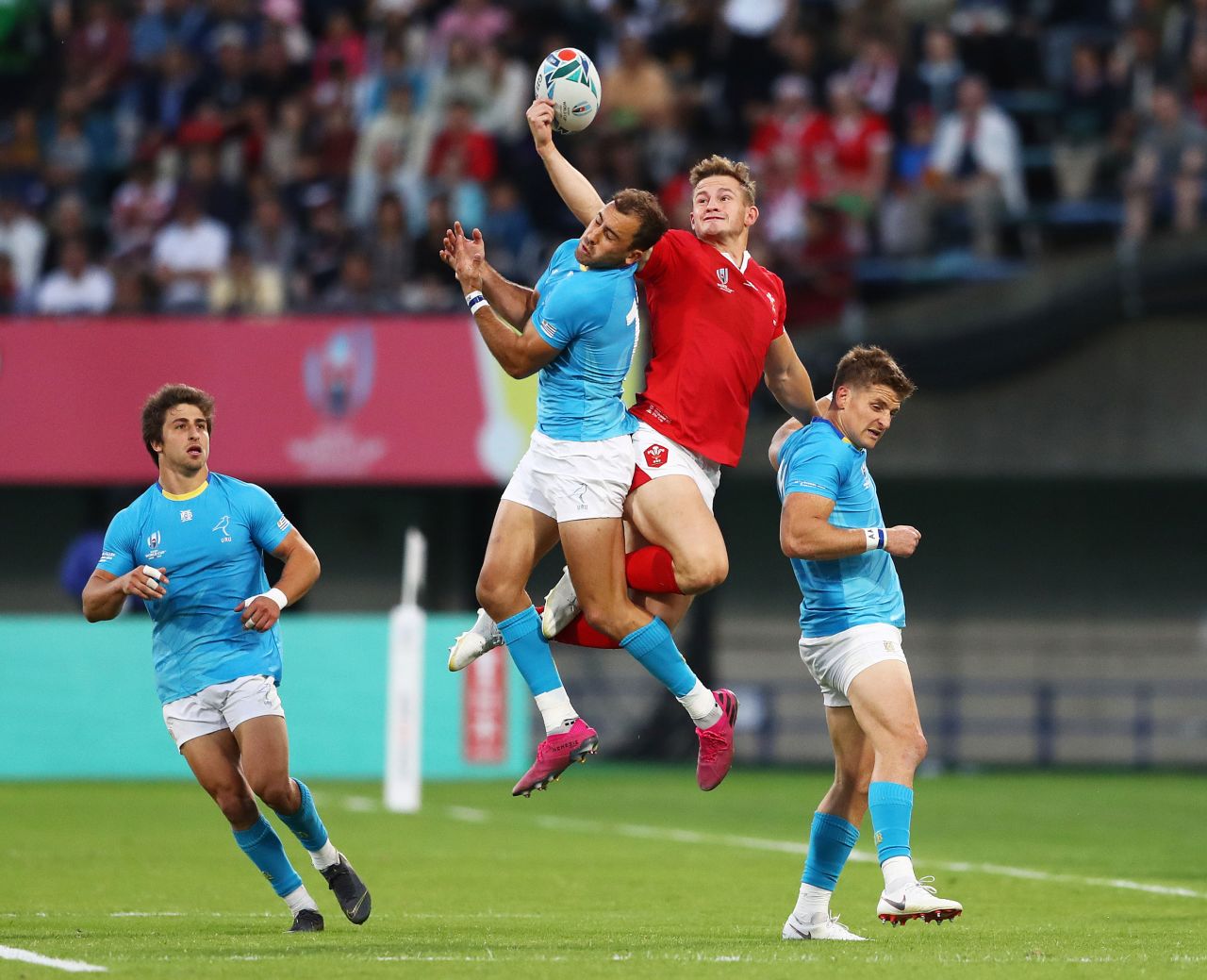 Hallam Amos of Wales and Gaston Mieres of Uruguay jump for a high ball. Wales beat Uruguay 35-13, qualifying them for a quarterfinal match against France.