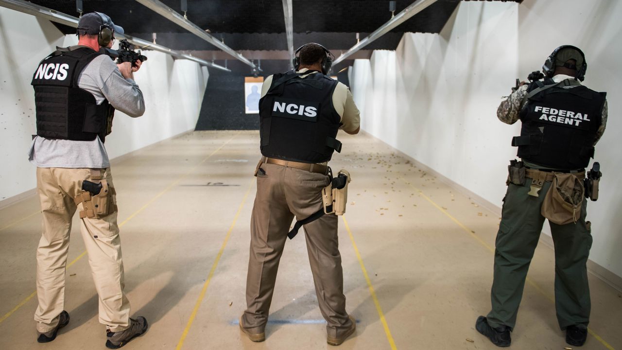 NCIS special agents fire the MK18 gun during range qualifications.