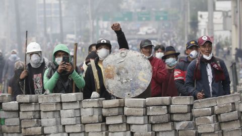 Anti-government demonstrators man a barricade during clashes with the police.