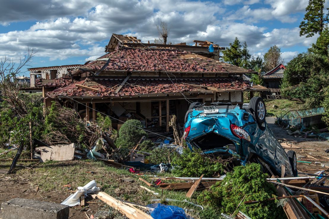 An upturned car lies next to a partially destroyed house after being hit by a tornado shortly before the arrival of Typhoon Hagibis, on October 13, 2019 in Chiba, Japan.