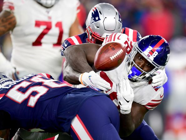New York Giants running back Jon Hilliman fumbles during an NFL game against the New England Patriots in Foxborough, Massachusetts, on Thursday, October 10. The Giants lost the game 35-14.